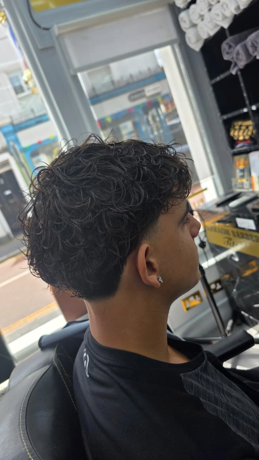 Back view of curly hair with a tapered neckline