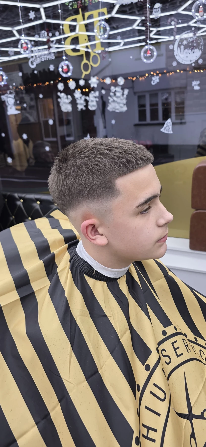 Young customer with a short textured haircut and skin fade