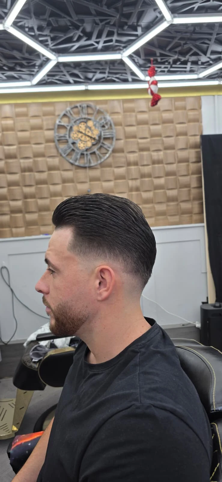 Side view of a short haircut with a skin fade