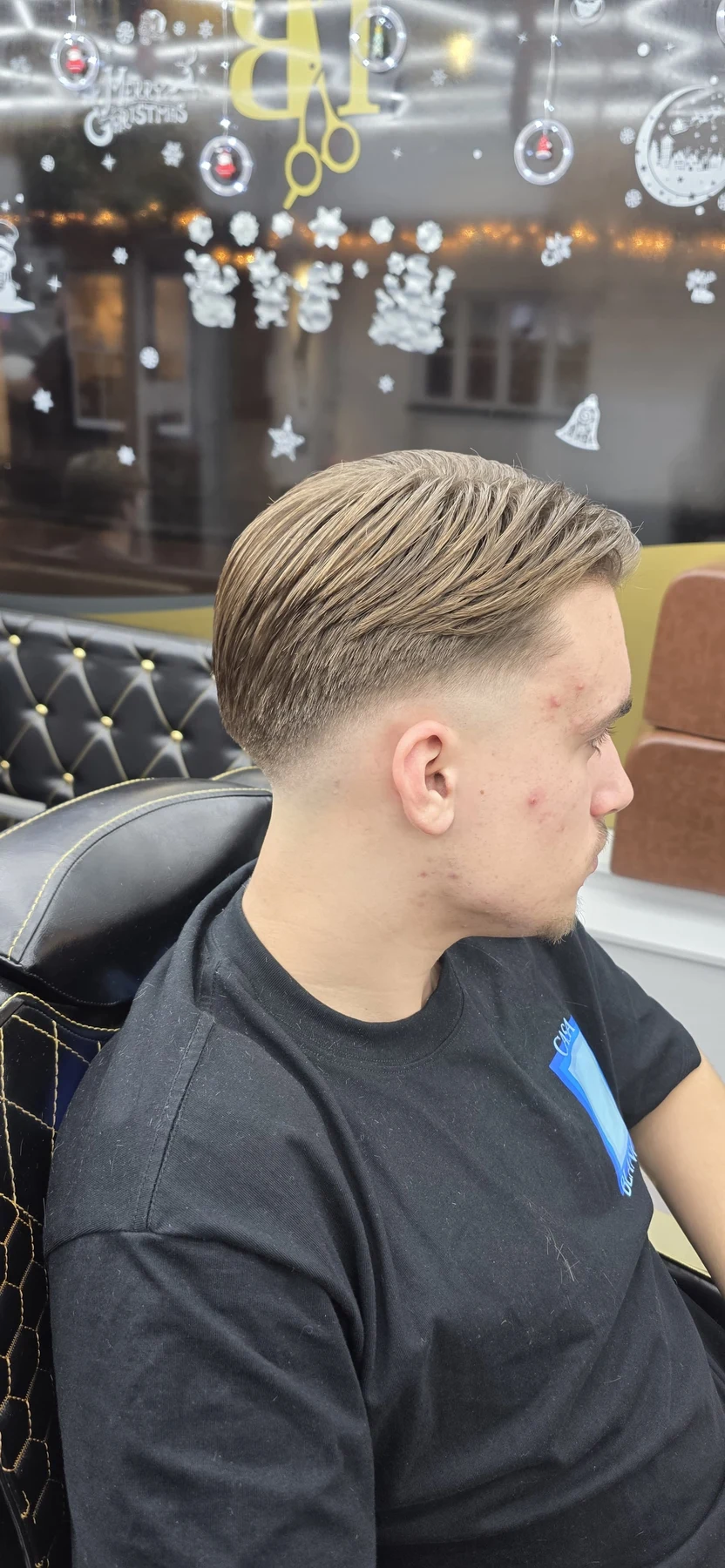 Side view of swept-back hair with closely faded sides