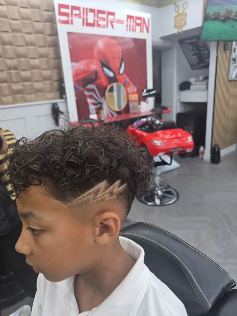 Kids curly haircut with a lightning design